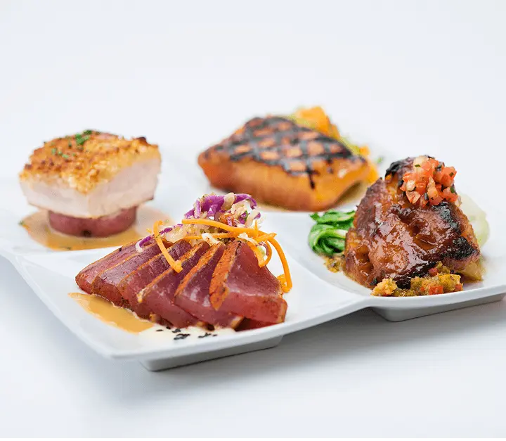 Seafood tasting platter with seared tuna, salmon, halibut, and short rib