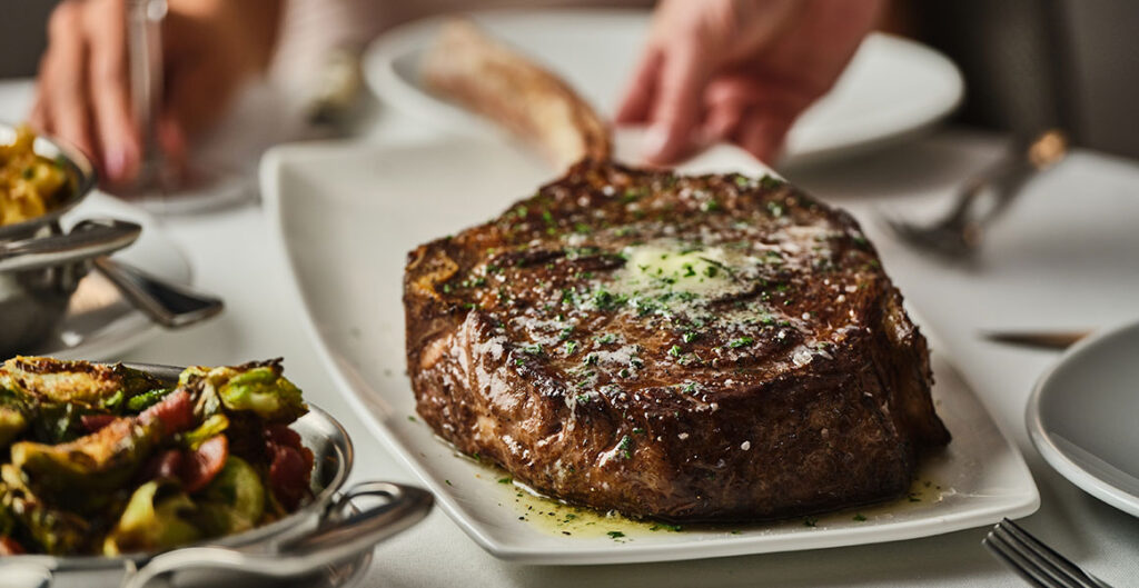 Fleming's tomahawk being served on the table
