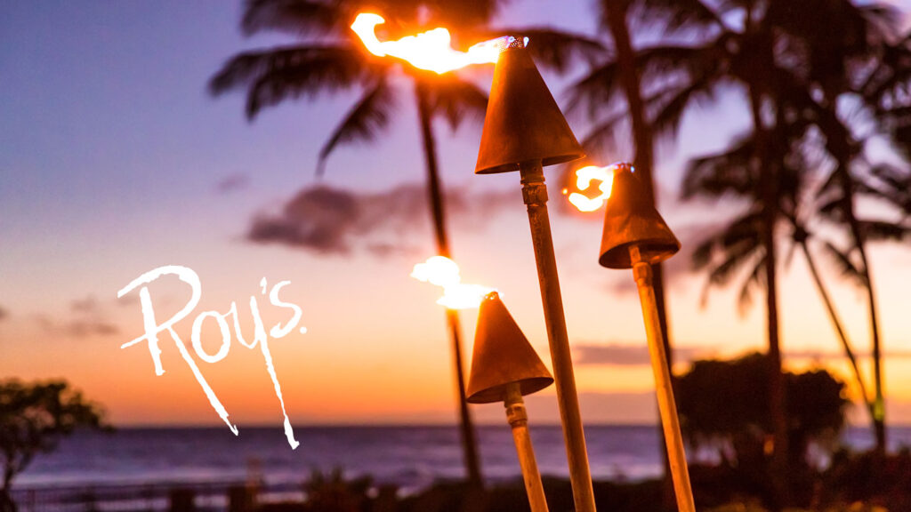roys logo with hawaiian evening sunset in background with tiki torches and palm trees