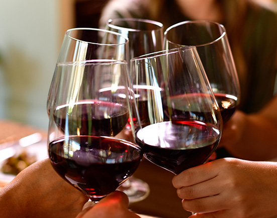 red wine glasses cheersing