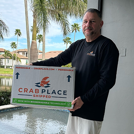 Greg Cain, the founder of Crab Place, holding one of the shipped box of premium, world-class seafood.